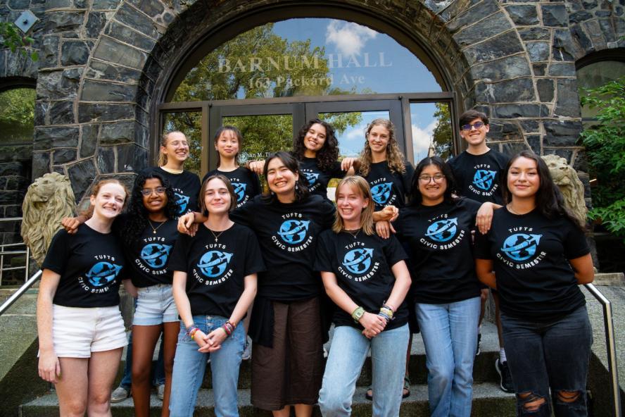 2023 Tufts Civic Semester sudents pose it matching black tshirts outside of Barnum Hall