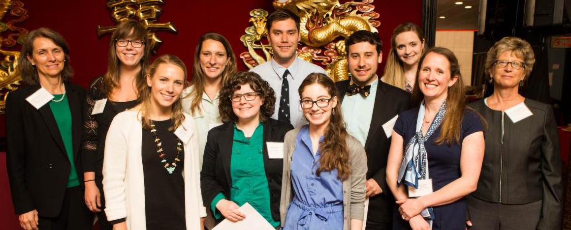 Group Photo of Students in front of a red and gold background