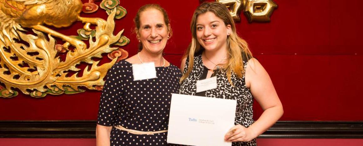 A student from Public Health and Professional Degree Programs receiving Honos Civicus Award