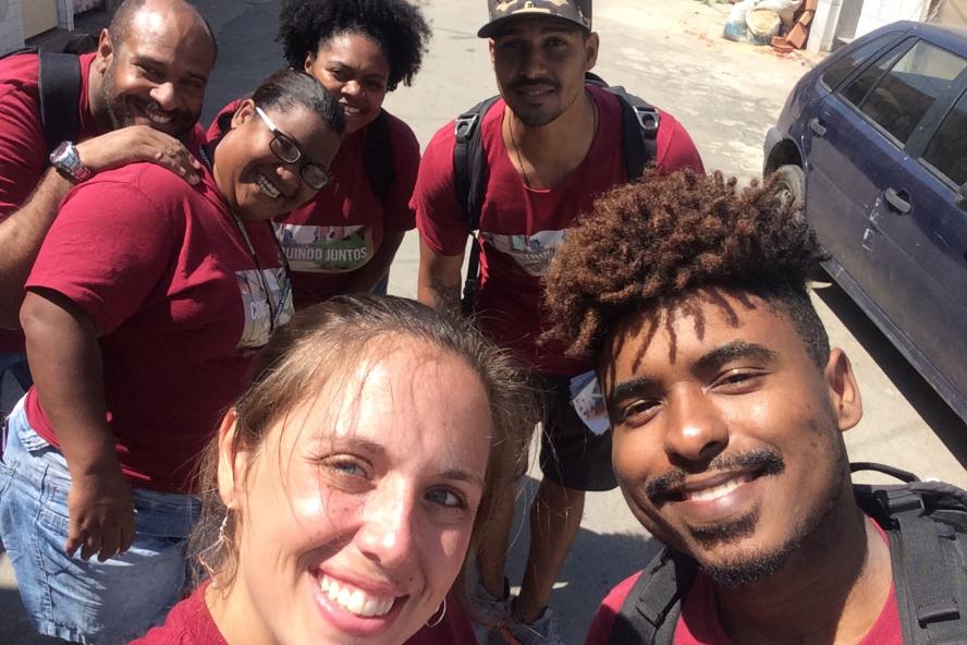 Outside Selfie of six students wearing matching maroon shirts