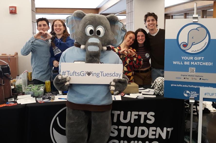 students and a person in an elephant costume during a Tufts Giving Tuesday event