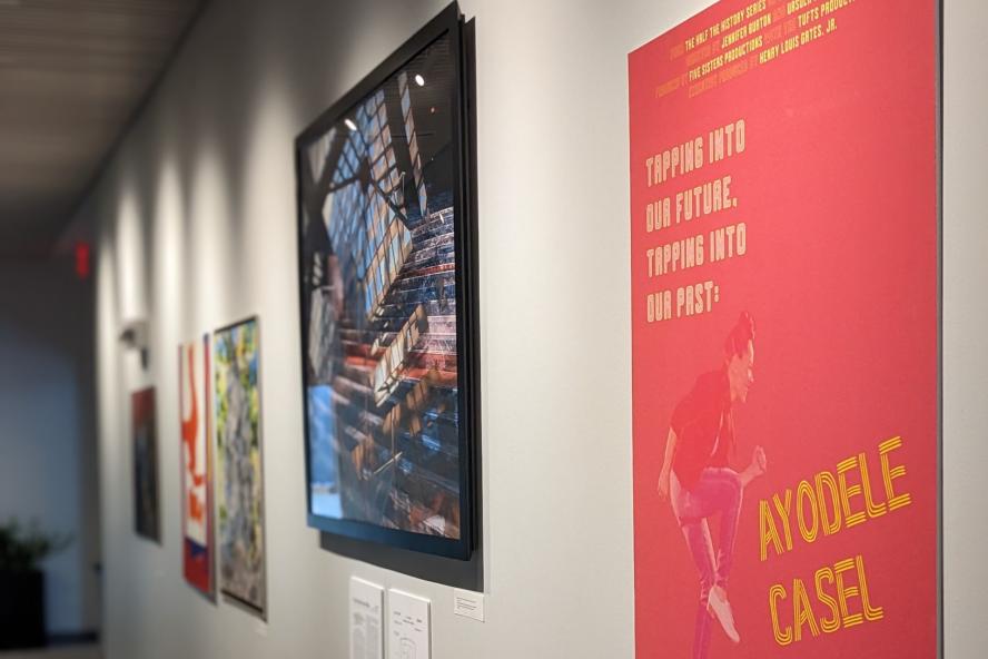 images from Half the History art exhibit on a white wall in the Barnum hall lobby