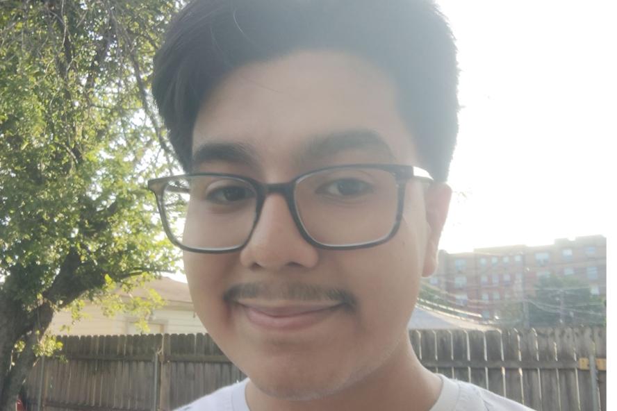 Image of Bryan, a civic semester student, in front of a fence and tree