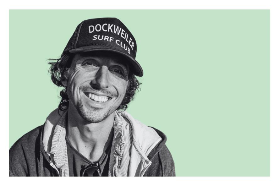 Nic Sheff smiling against a green background. 