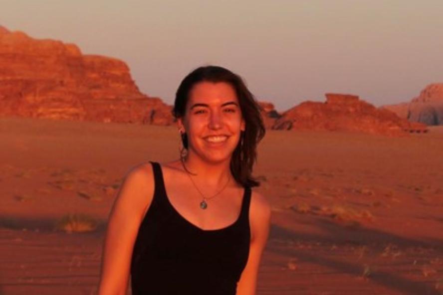 Alexandra Dingle Headshot outside in front of red rocks