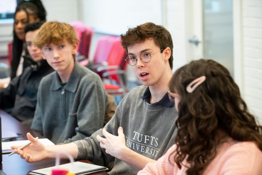 students in classroom speaking at table