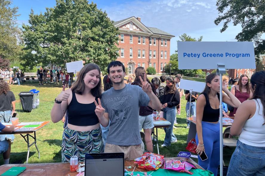 Students at Tufts club fair on main quad with a sign that reads Petey Greene Program