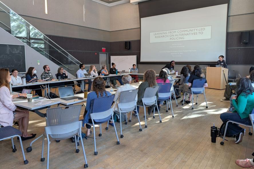 Group of community members in a classroom watching a presentation