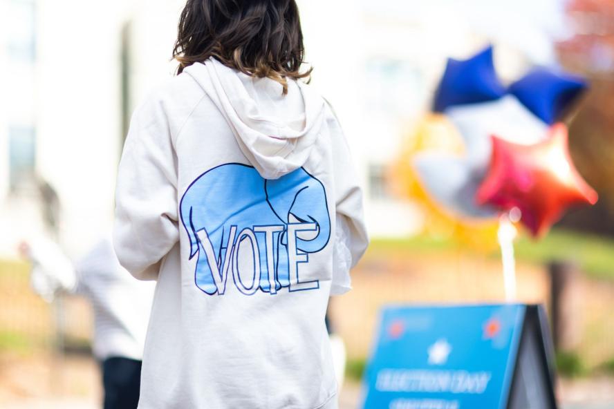 Back of a sweatshirt with a blue elephant that says VOTE