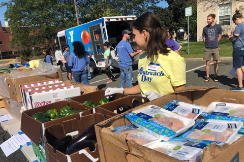 Tufts students help with a pop-up food pantry run by the Malden Y M C A