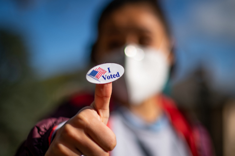 person holding an "I Voted" sticker
