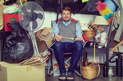 person holding a tennis racket surrounded by various objects