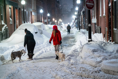Cars and sidewalks are buried in snow after a Boston snowstorm in 2022.