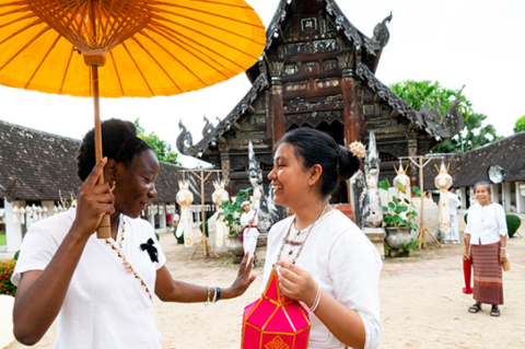Kaliyah Cherubin, A29, and Brandy Gutierrez, A29, share a laugh during a visit to Wat Intharawat, an old-style wooden Buddhist temple built in 1852.