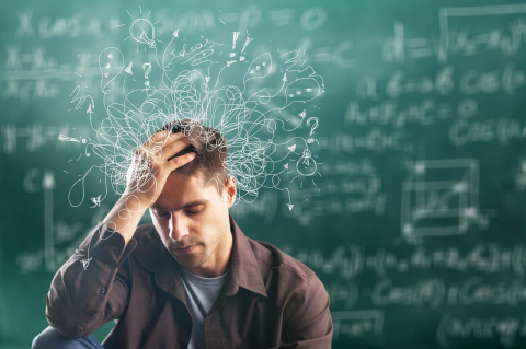 A man sits with a hand on his forehead and swirling thoughts are illustrated above his head.